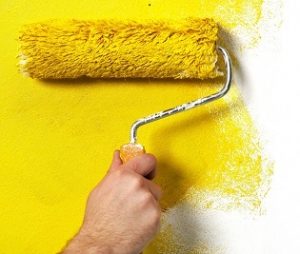 Hand with paint roller